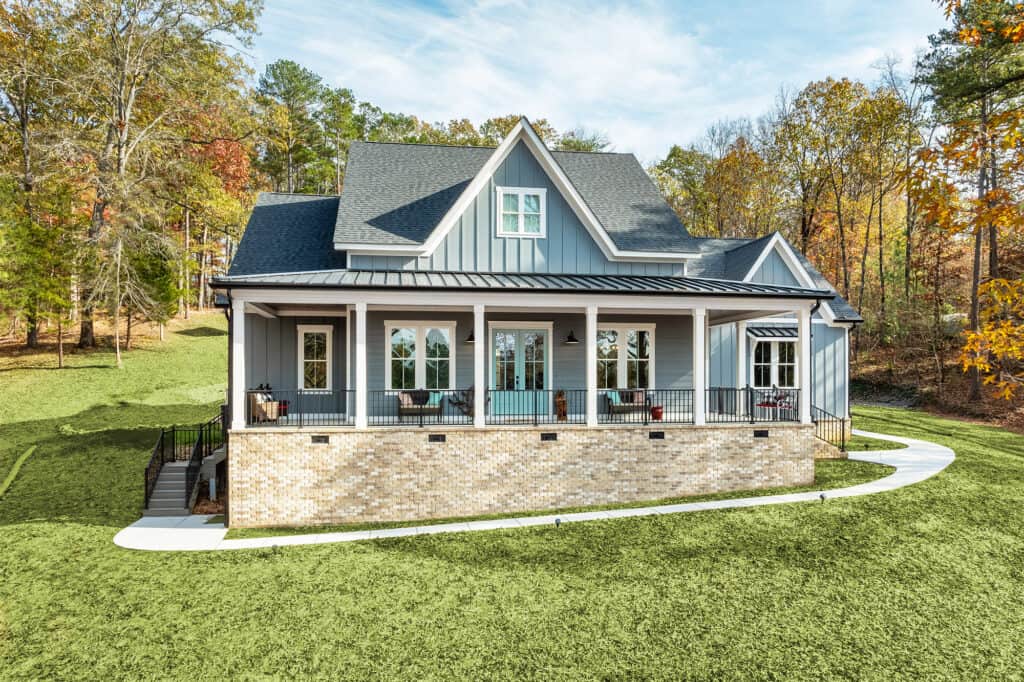 front of a blue country home